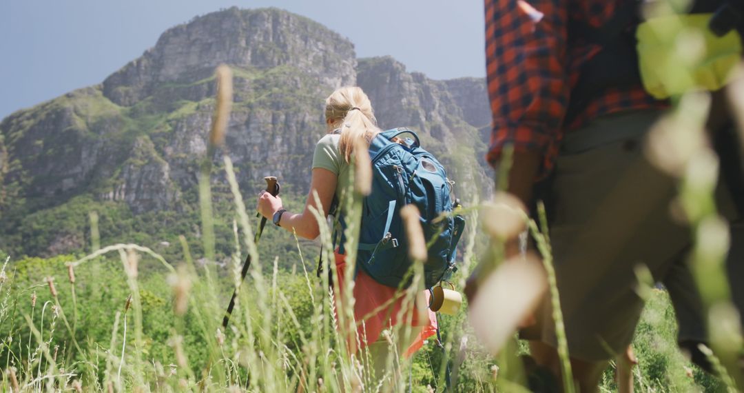 Happy diverse couple hiking with backpacks in mountains, slow motion ...