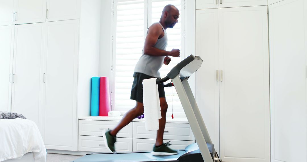 Middle-Aged Man Running on Treadmill in Modern Home Gym - Free Images, Stock Photos and Pictures on Pikwizard.com