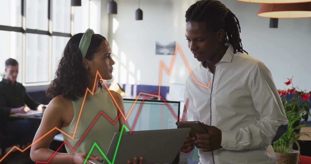 Business Professionals Analyzing Financial Data with Graphs in Modern Office
