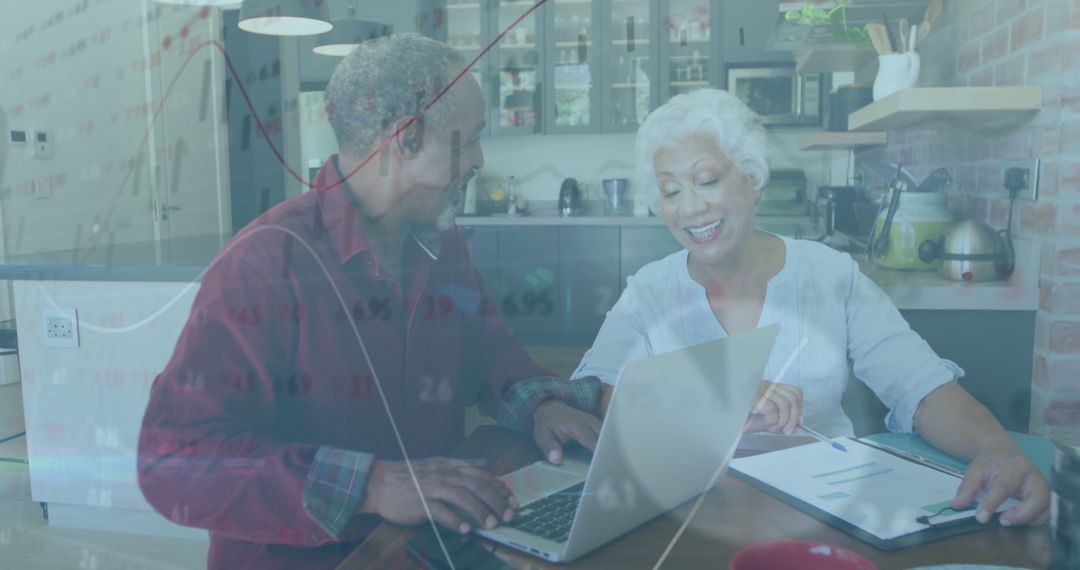 Mother and Son Collaborating at Home with Laptop and Documents