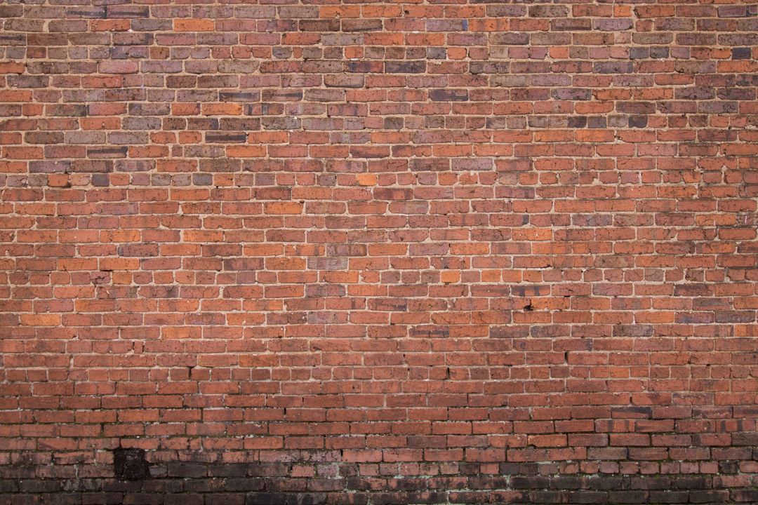 Plain aged red brick wall background with weathered texture