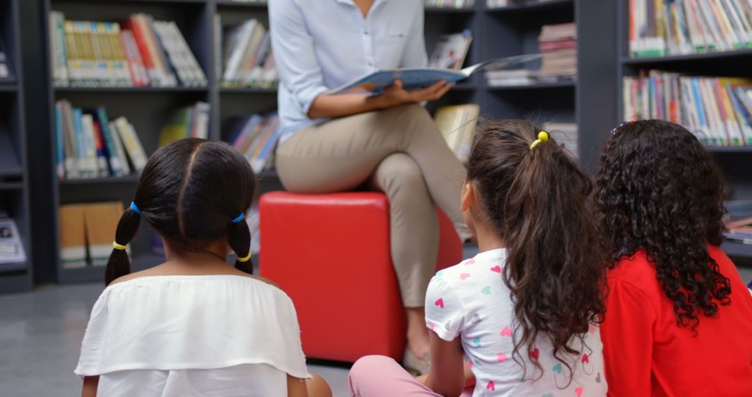 Teacher Engaging School Children with Storytime in Library