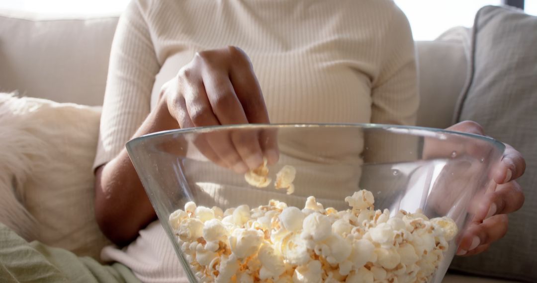 Person Grabbing Popcorn from a Bowl at Home - Free Images, Stock Photos and Pictures on Pikwizard.com