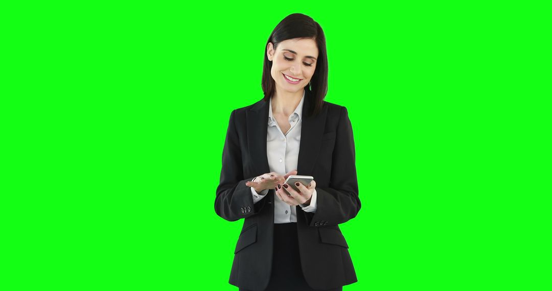 Businesswoman Smiling and Using Smartphone Against Green Screen - Free Images, Stock Photos and Pictures on Pikwizard.com