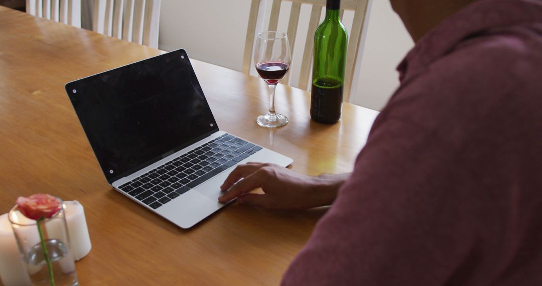 Man Working on Laptop with Wine at Home - Free Images, Stock Photos and Pictures on Pikwizard.com