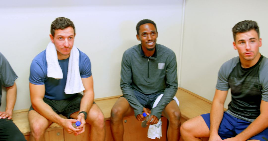 Group of Male Athletes Resting in Locker Room After Workout - Free Images, Stock Photos and Pictures on Pikwizard.com