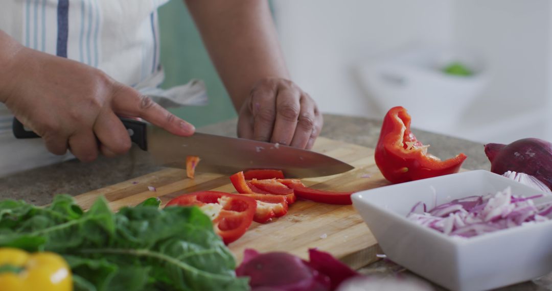 Close-Up of Person Chopping Red Bell Pepper in Kitchen - Free Images, Stock Photos and Pictures on Pikwizard.com