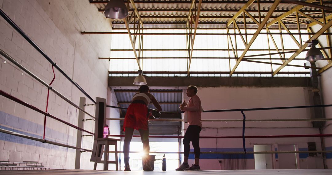 Boxer Resting in Training Gym with Coach at Dawn - Free Images, Stock Photos and Pictures on Pikwizard.com