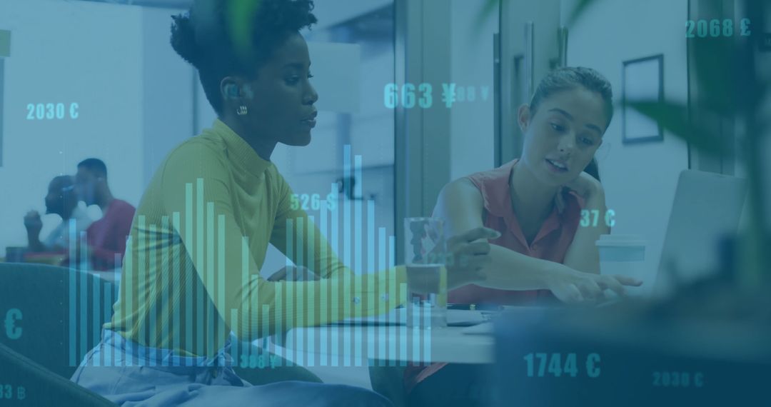 Diverse Female Colleagues Discussing Data Analysis in Modern Office