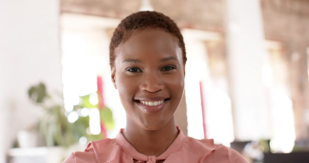 Confident Black Woman Smiling in Modern Office Workspace - Free Images, Stock Photos and Pictures on Pikwizard.com