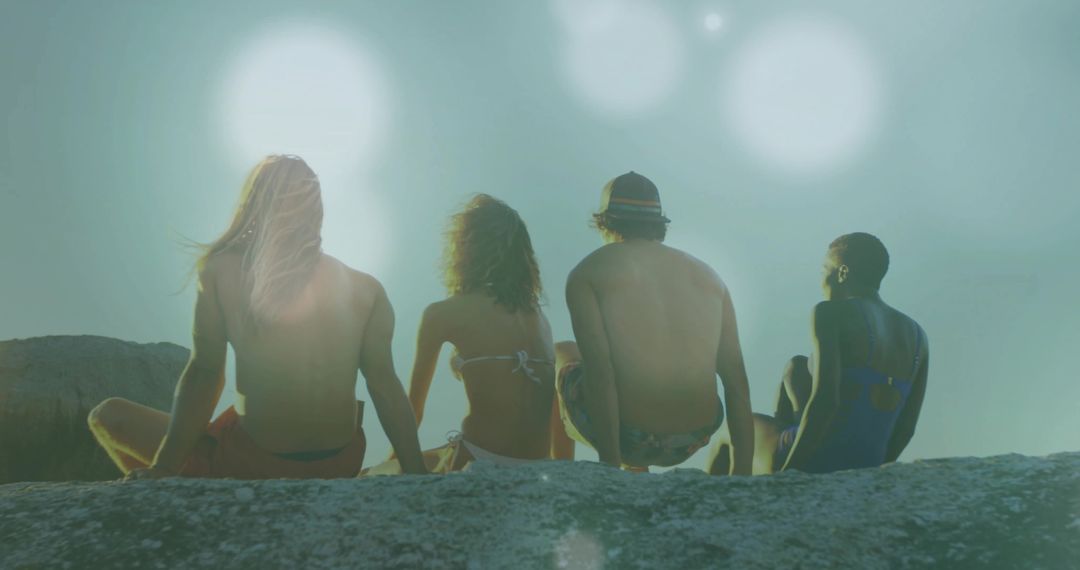 Friends Enjoying Sunny Day Together on Rock Ledge