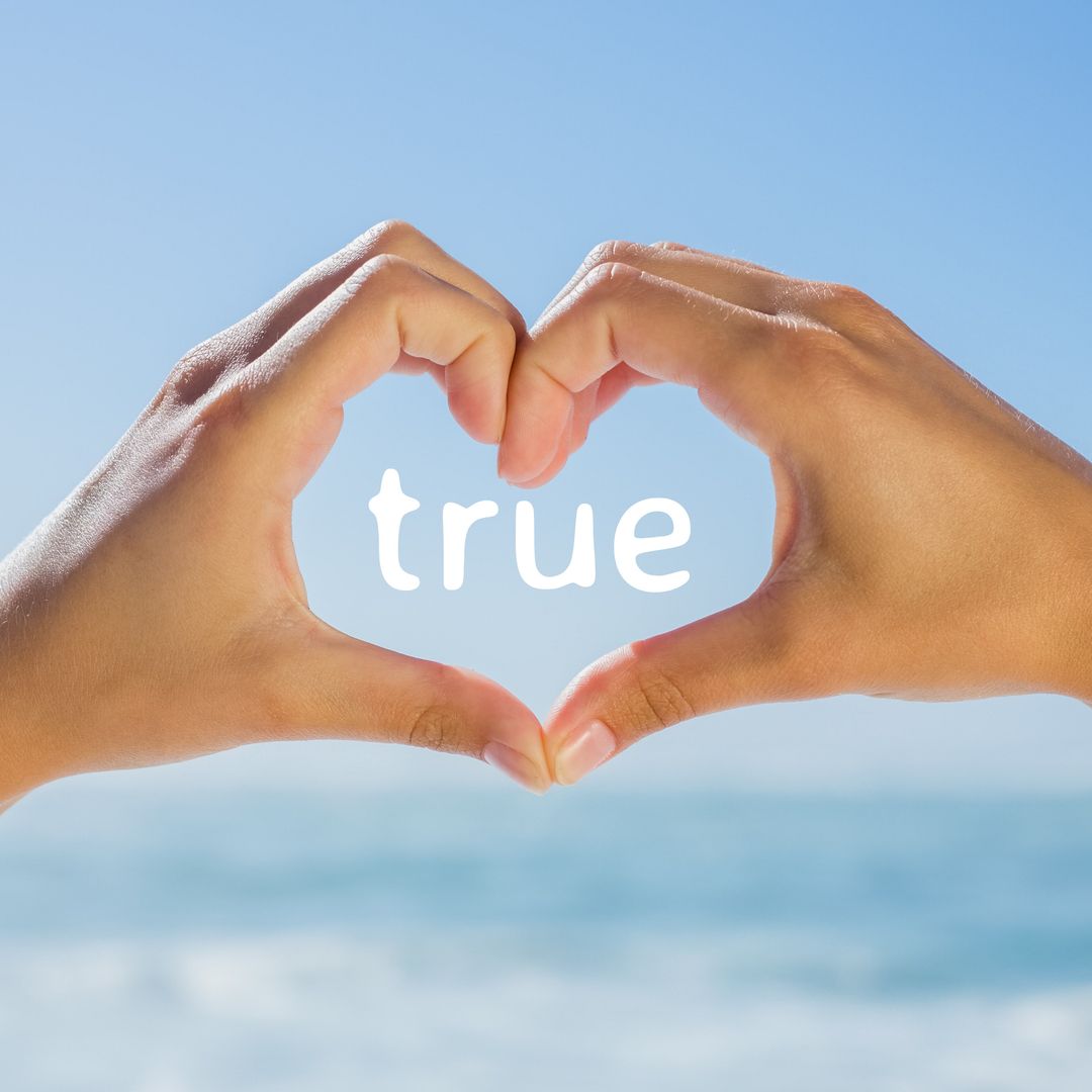 Hands Forming Heart with Love Message Against Blue Sky