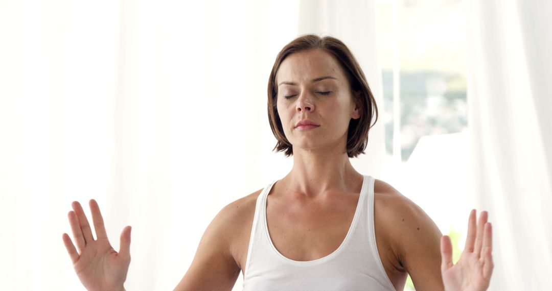 Woman Meditating Indoors with Eyes Closed - Free Images, Stock Photos and Pictures on Pikwizard.com