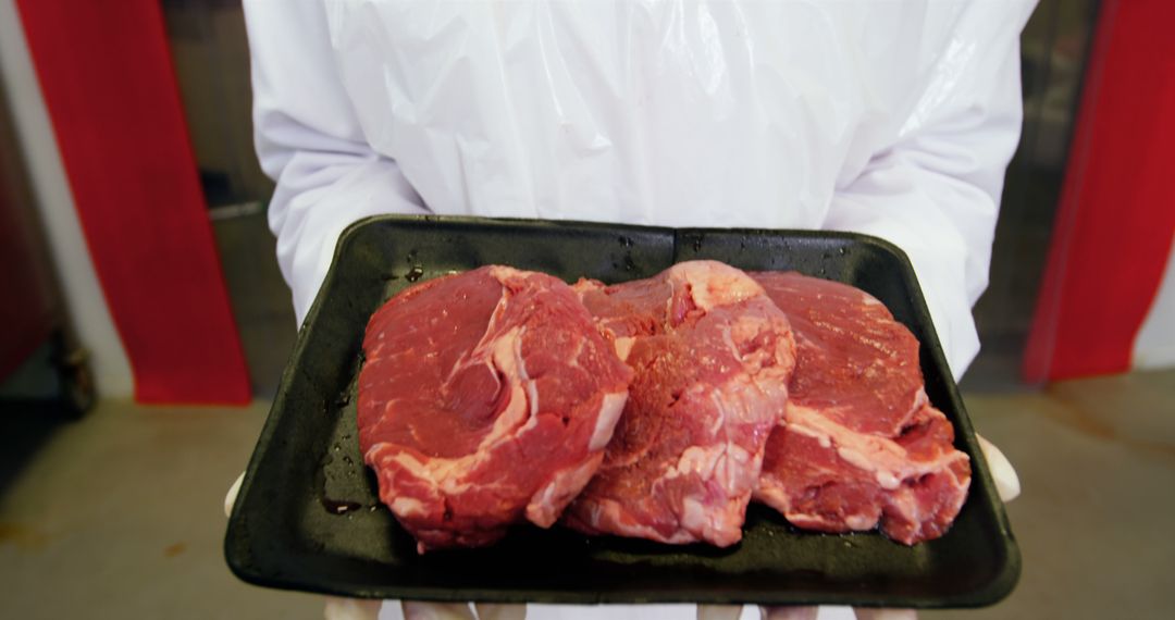 Butcher Holding Fresh Raw Beef Steaks on Tray - Free Images, Stock Photos and Pictures on Pikwizard.com