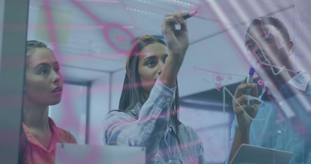 Team Analyzing Data on Transparent Board in Modern Office