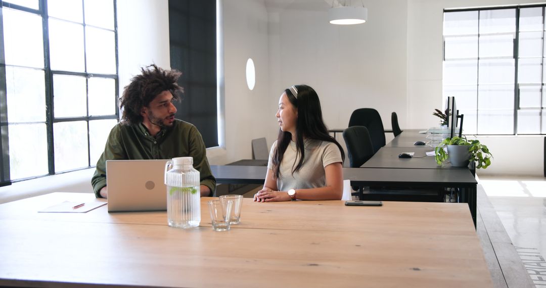 Colleagues Discussing Business Collaboration in Modern Office