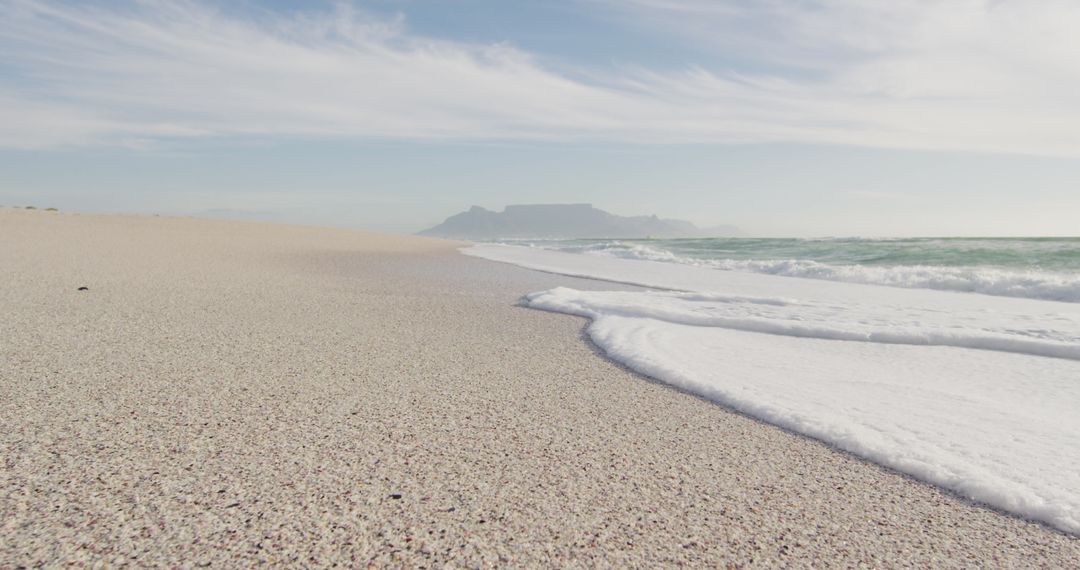 Idyllic Seascape with Gentle Waves and Expansive Beach