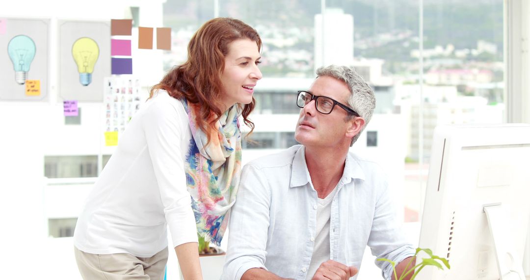 Colleagues Discussing Ideas in Bright Modern Office