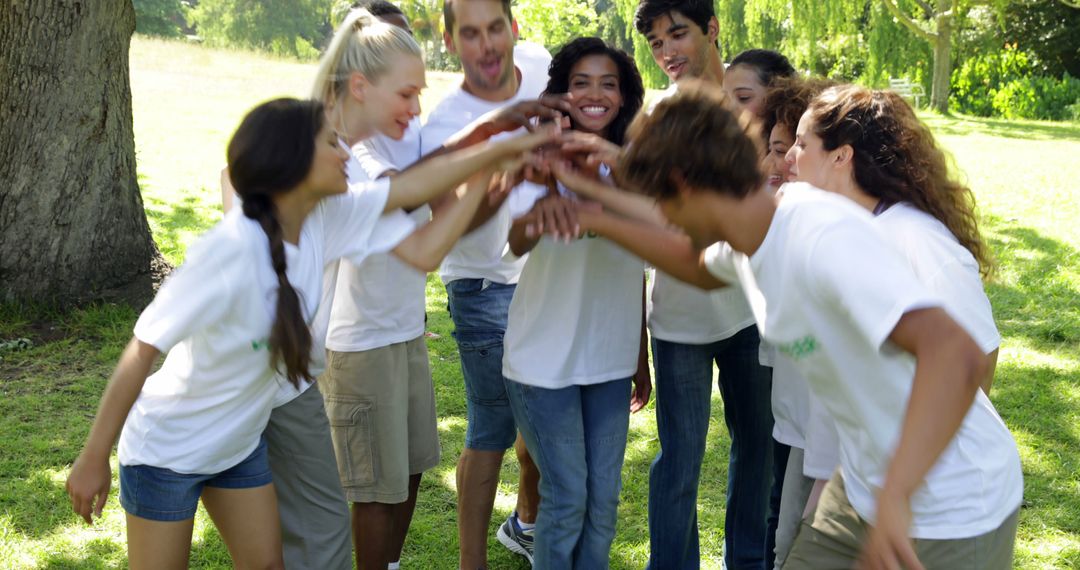 Group of volunteers putting their hands together on a sunny day - Free Images, Stock Photos and Pictures on Pikwizard.com