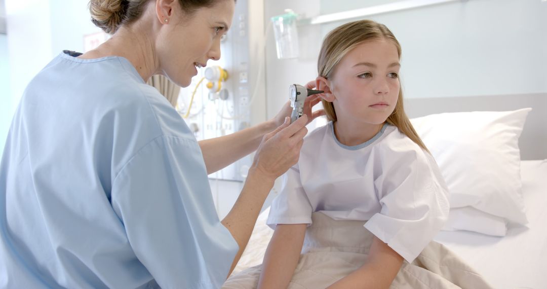 Nurse Checking Young Girl's Ear in Hospital Room - Free Images, Stock Photos and Pictures on Pikwizard.com