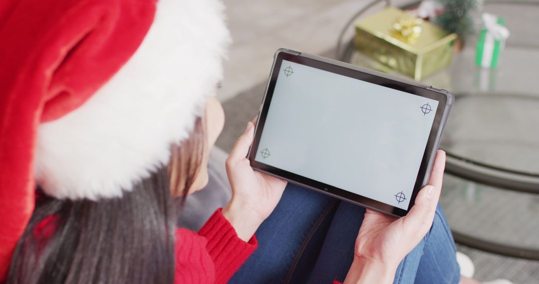 Woman Using Digital Tablet with Blank Screen During Christmas - Free Images, Stock Photos and Pictures on Pikwizard.com