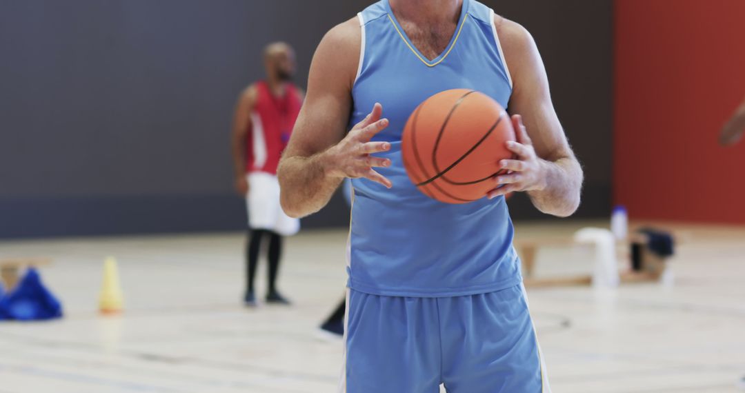 Focused Midsection View of Basketball Player on Indoor Court