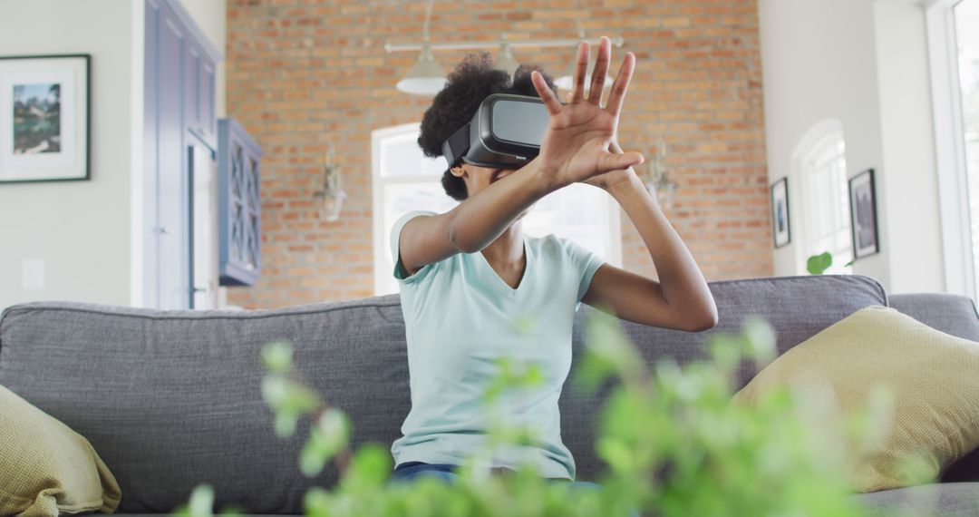 Young Woman Experiencing Virtual Reality in Home Setting - Free Images, Stock Photos and Pictures on Pikwizard.com