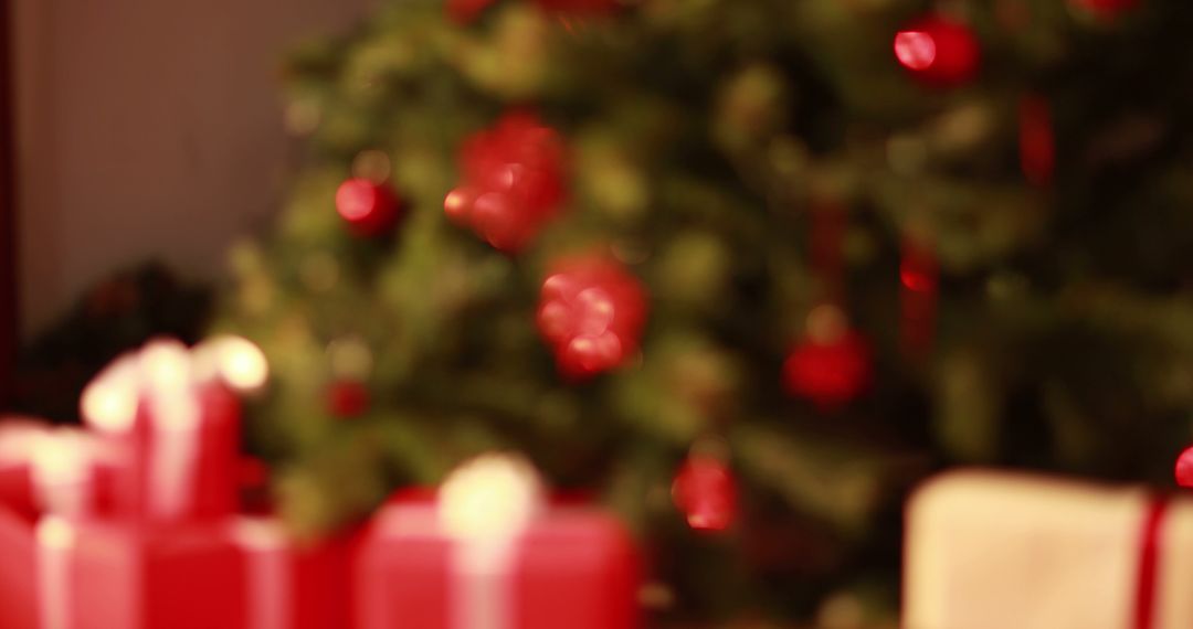 Christmas Tree with Blurry Decorated Background and Red Gift Boxes - Free Images, Stock Photos and Pictures on Pikwizard.com