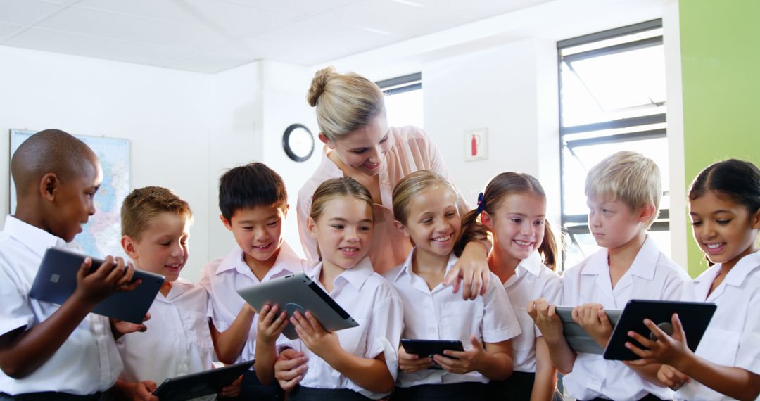 Smiling Students and Teacher Using Tablets in Classroom - Free Images, Stock Photos and Pictures on Pikwizard.com