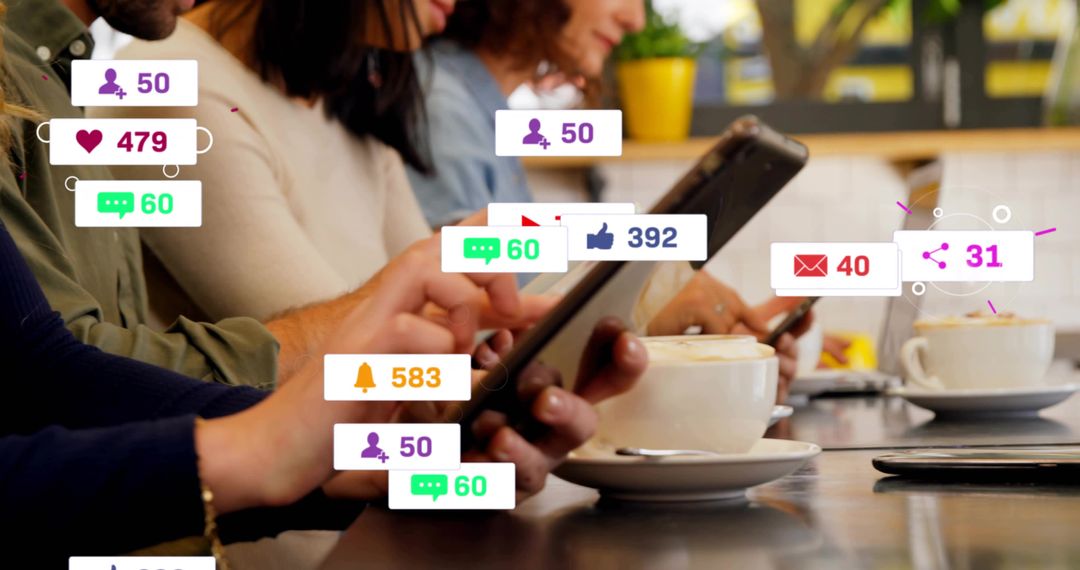 Tapping tablet and smartphone at cafe counter with social media notifications and coffee