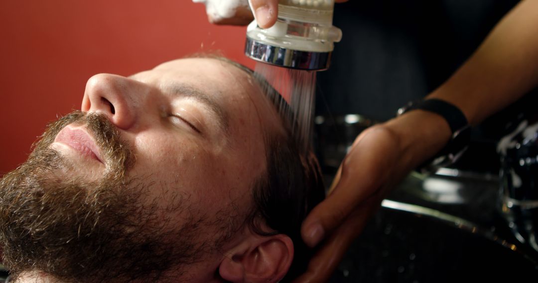 Man Relaxing While Having Hair Washed at a Barbershop - Free Images, Stock Photos and Pictures on Pikwizard.com