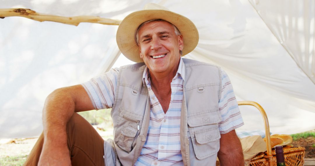 Elderly Man Enjoying Sunny Day in Nature During Picnic - Free Images, Stock Photos and Pictures on Pikwizard.com