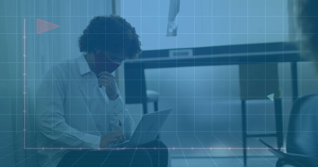 Man with Laptop and Mask in Modern Workspace with Grid Overlay