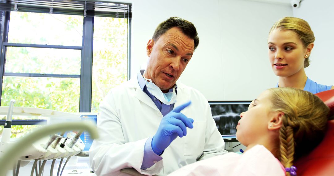 Dentist Discussing Procedure with Young Patient, Focus on Patient Comfort