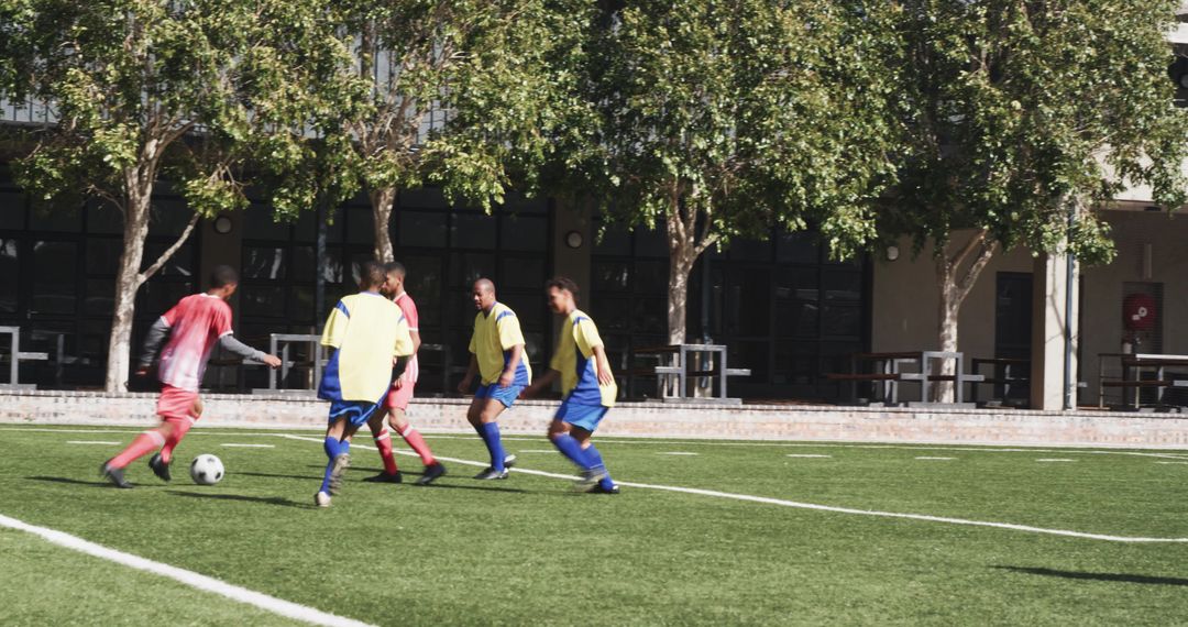 Soccer Players Practicing Passing and Defense on Field