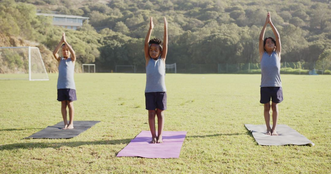 Diverse Boys Practicing Mountain Pose Outdoors on Sunny Day