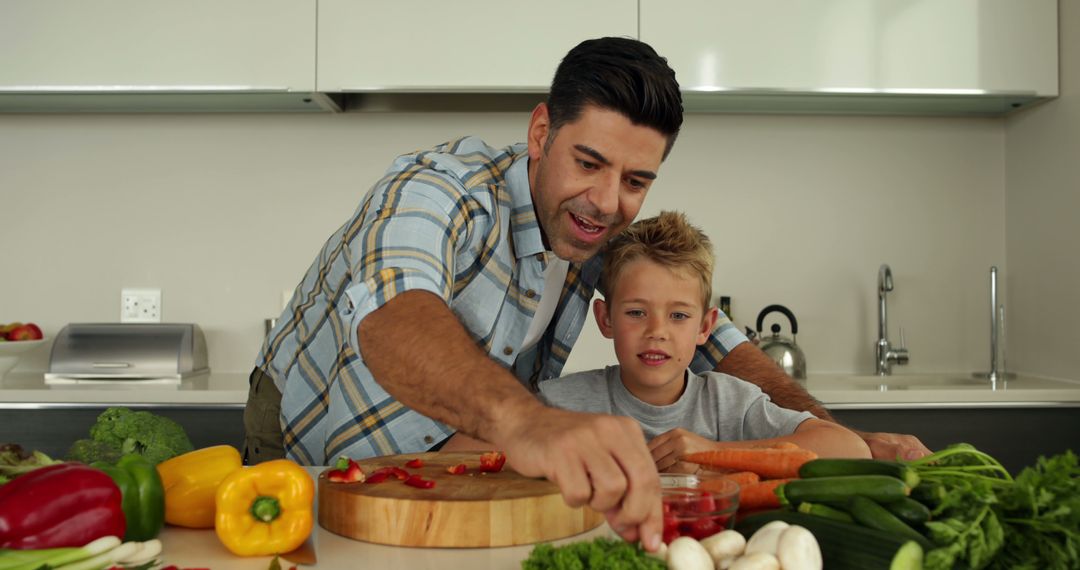 Father and son preparing vegetables in modern kitchen - Free Images, Stock Photos and Pictures on Pikwizard.com