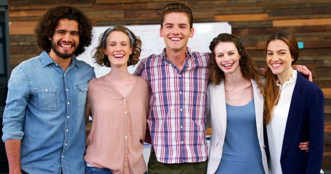 Diverse Group Of Young Adults Smiling In Office Environment - Free Images, Stock Photos and Pictures on Pikwizard.com