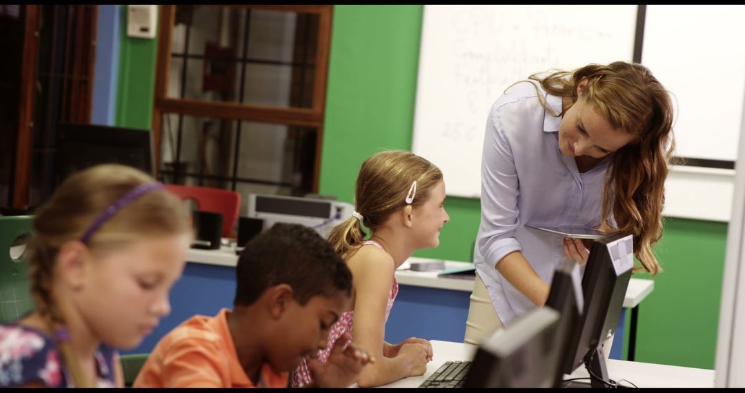 Teacher Guiding Engaged Students Using Computers in Modern Classroom