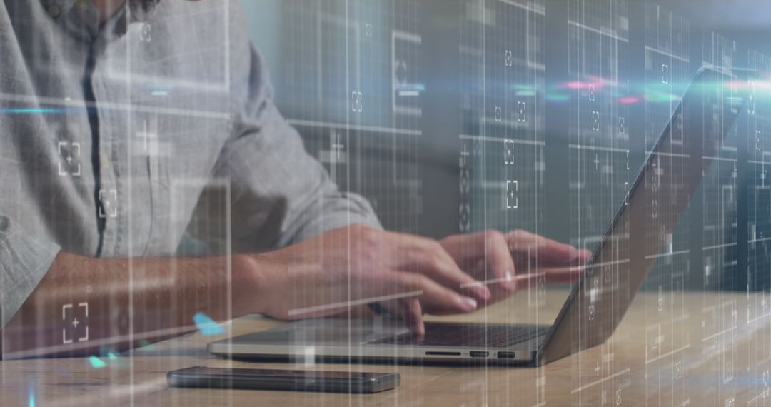 Person Typing on Laptop with Digital Interface Overlay