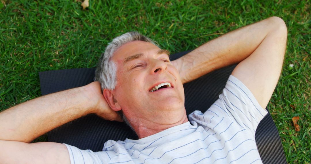 Senior Man Relaxing on Grass with Hands Behind Head and Smiling - Free Images, Stock Photos and Pictures on Pikwizard.com