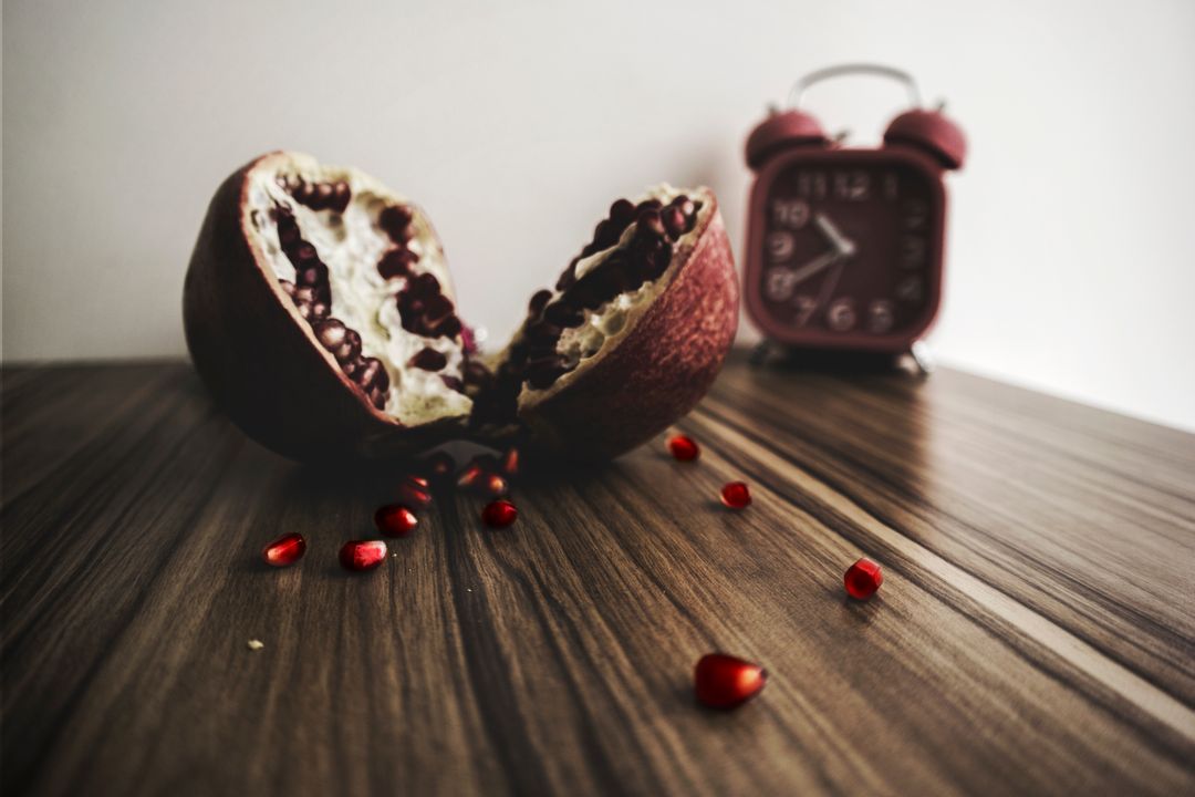 Red and White Round Fruit on Brown Wooden Table With Red Alarm Clock - Free Images, Stock Photos and Pictures on Pikwizard.com
