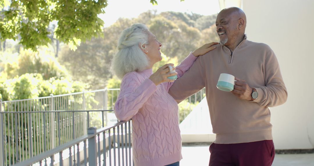 Happy Senior Couple Enjoying Coffee on Sunny Balcony - Free Images, Stock Photos and Pictures on Pikwizard.com