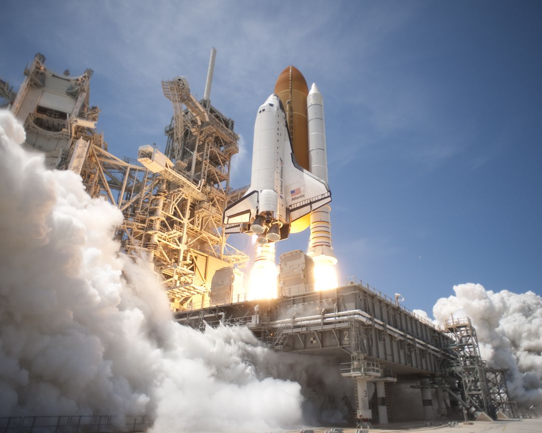 Space Shuttle Launching with Billowing Smoke Against Clear Blue Sky - Free Images, Stock Photos and Pictures on Pikwizard.com