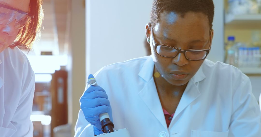 African American Female Scientist Working in Modern Research Laboratory - Free Images, Stock Photos and Pictures on Pikwizard.com