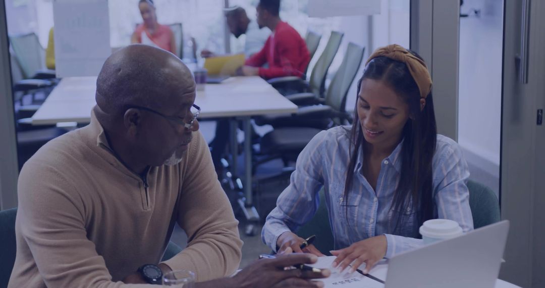 Diverse Colleagues Collaborating at Office Conference Table