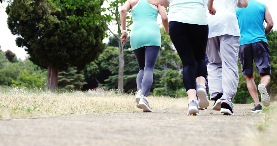 Group of Friends Jogging Together in Park - Free Images, Stock Photos and Pictures on Pikwizard.com