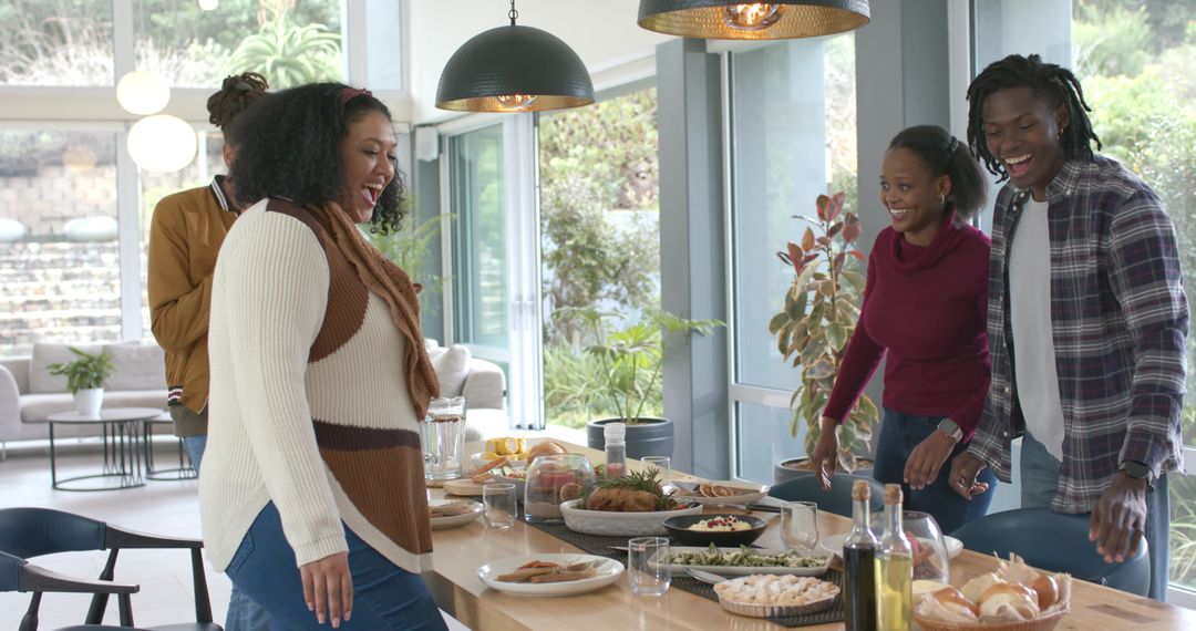 Friends Gathering and Laughing Serving Feast on Long Wooden Dining Table in Modern Home
