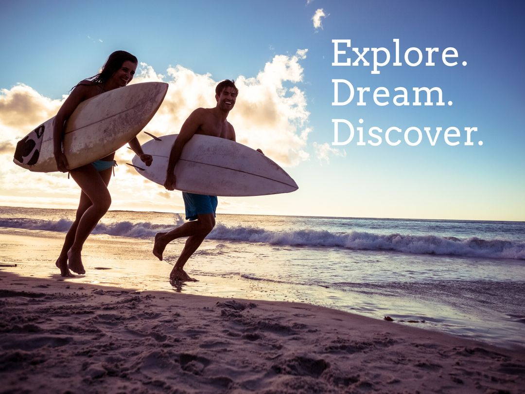 Couple on Beach with Surfboards at Sunset Promoting Adventure
