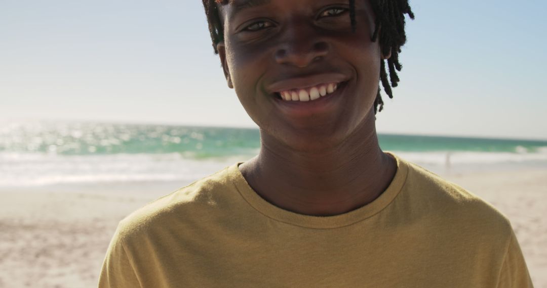 Smiling Person Enjoying Sunny Day at Beach - Free Images, Stock Photos and Pictures on Pikwizard.com